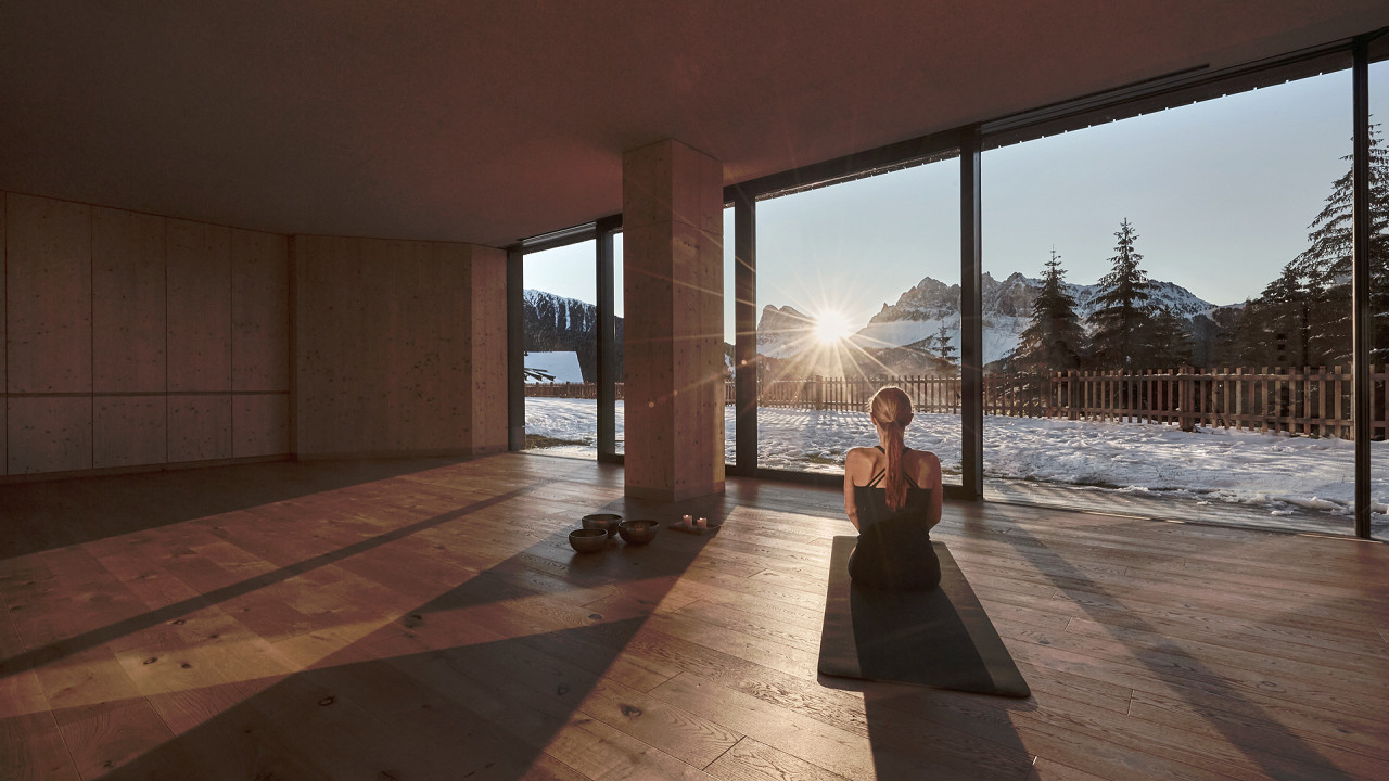 Femme pratiquant le yoga en hiver FORESTIS Bressanone