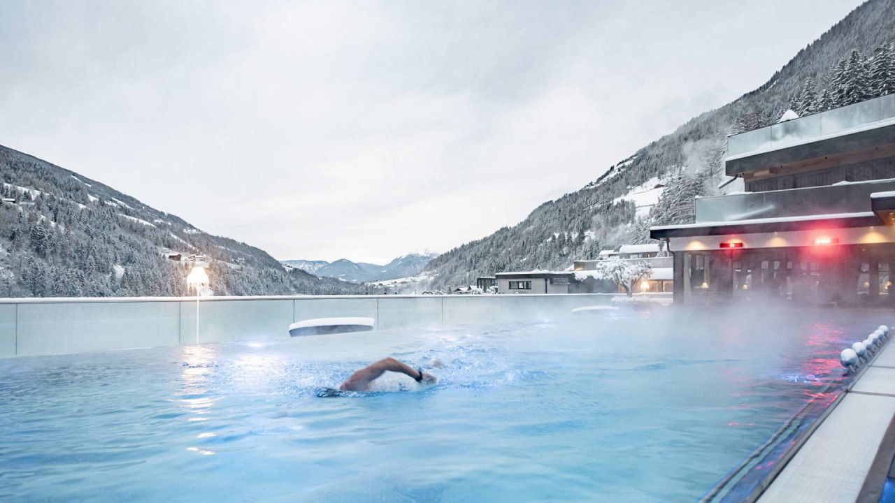 Outdoor swimming pool winter Quellenhof Luxury Resort Passeier
