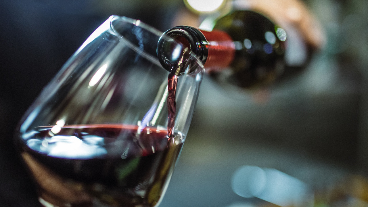 Goblet of red wine with bottle